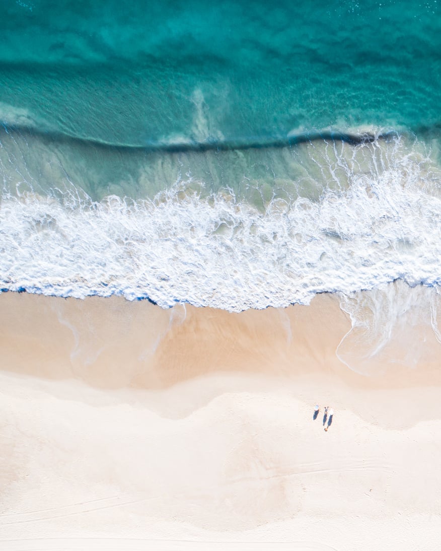 Aerial view of a beach and water.